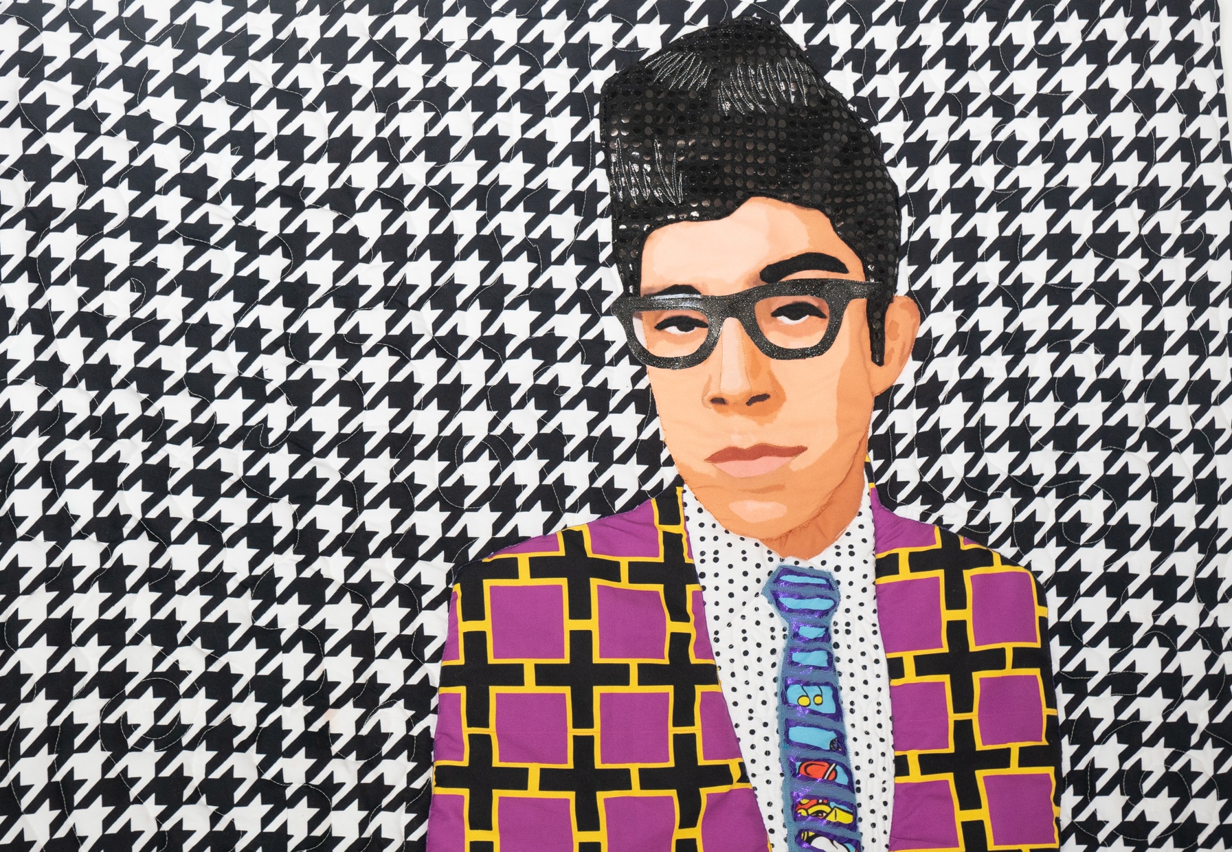 Detail of a collage portrait of a Latino man wearing a tie and plus-sign patterned jacket on a patterned background. 