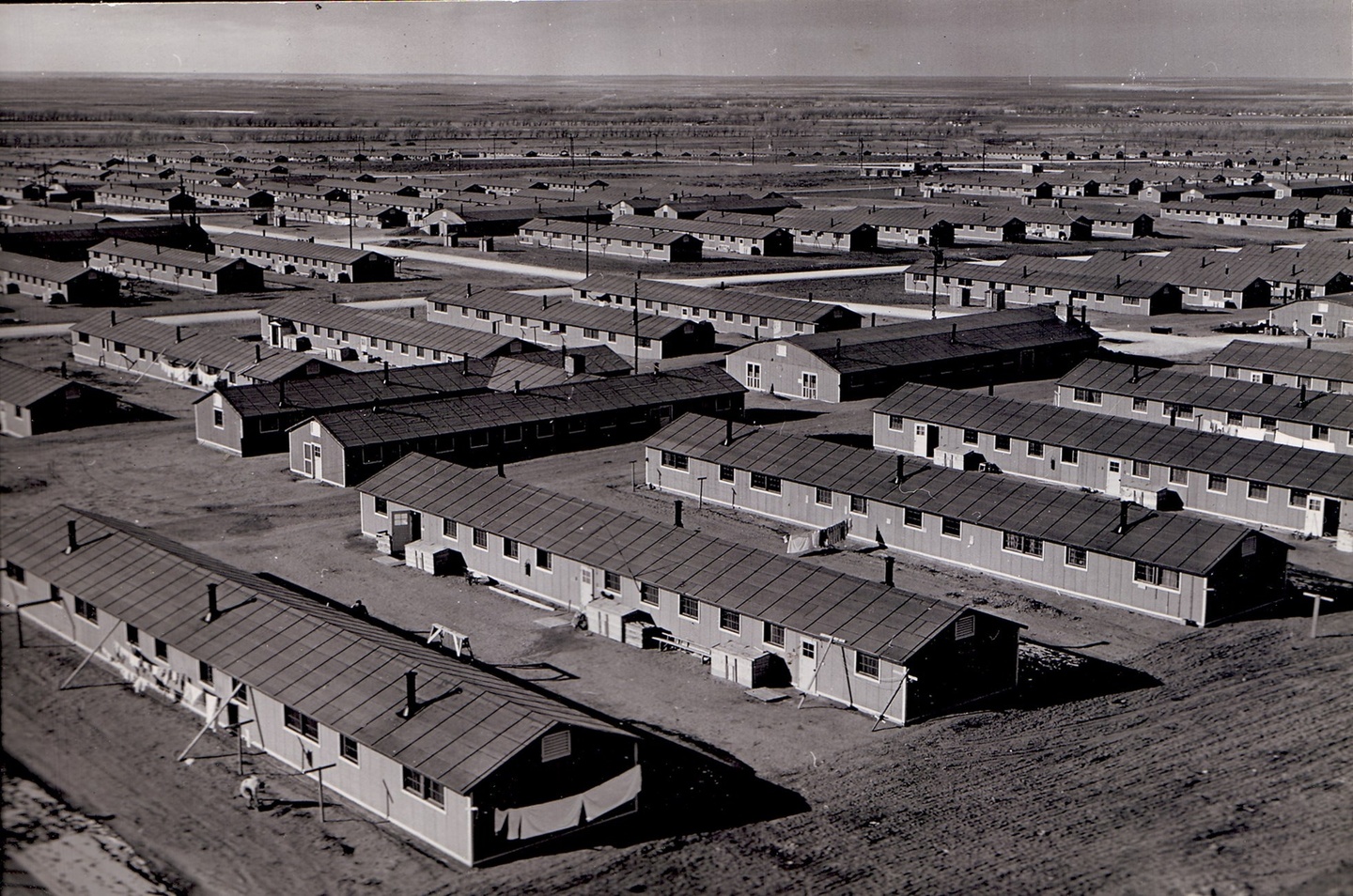 Black-and-white photo of living quarters at a war relocation camp.