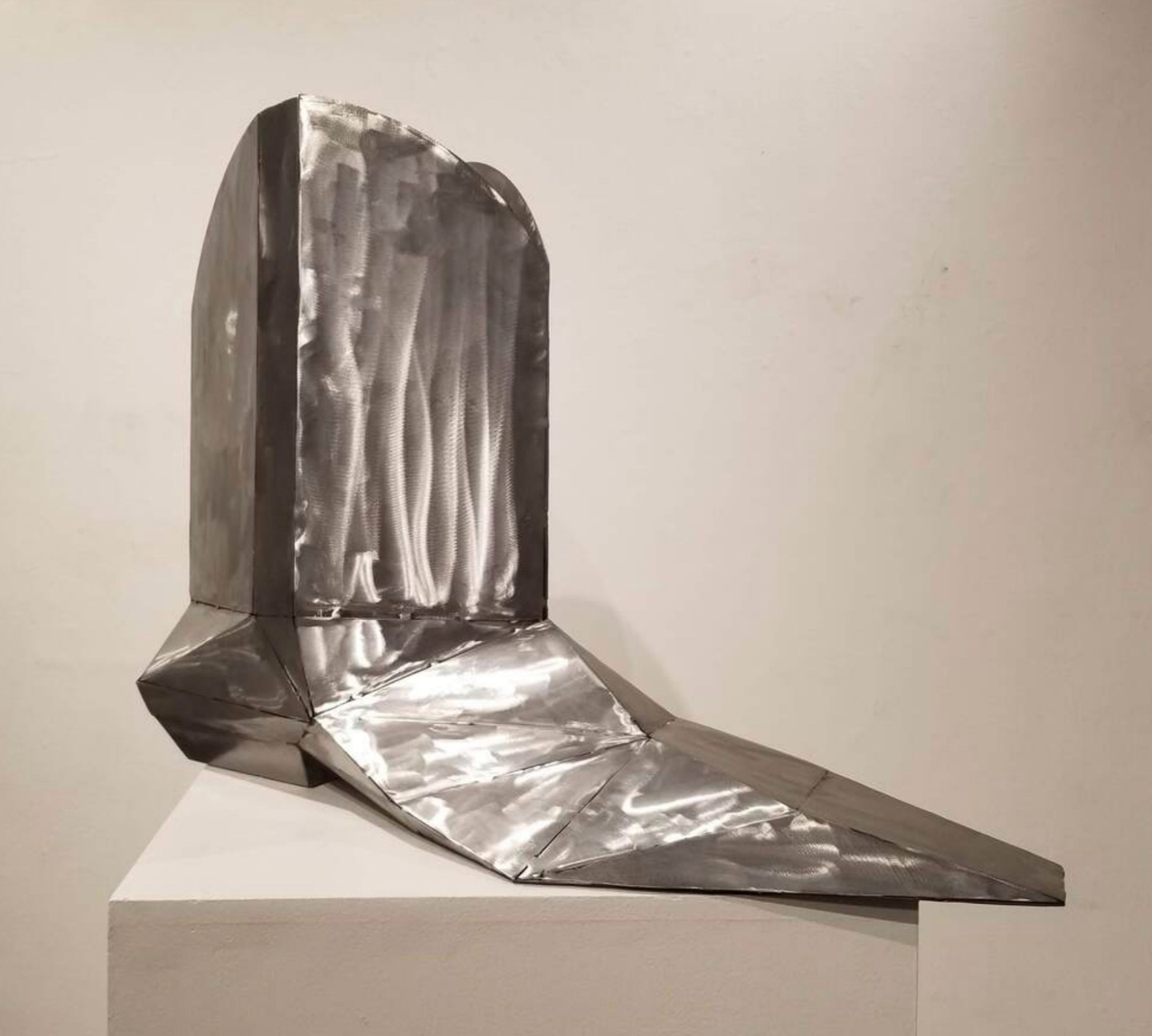 A welded metal bootlike sculpture. 