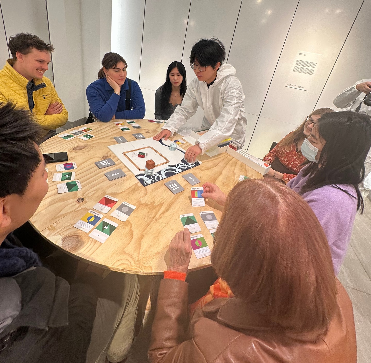 people playing a board game around a table