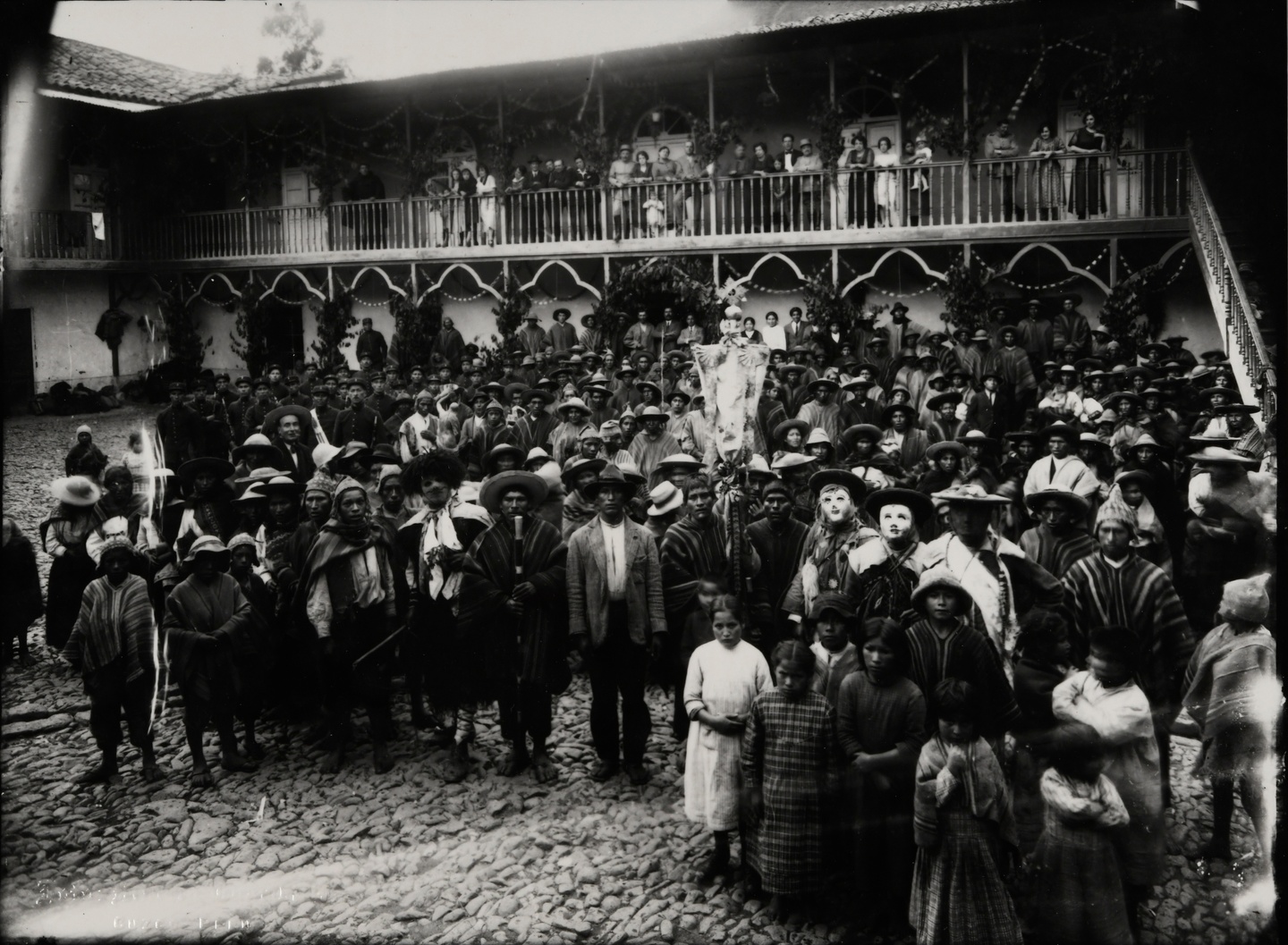 Black-and-white photo of a crowd gathered in celebration in a Peruvian courtyard