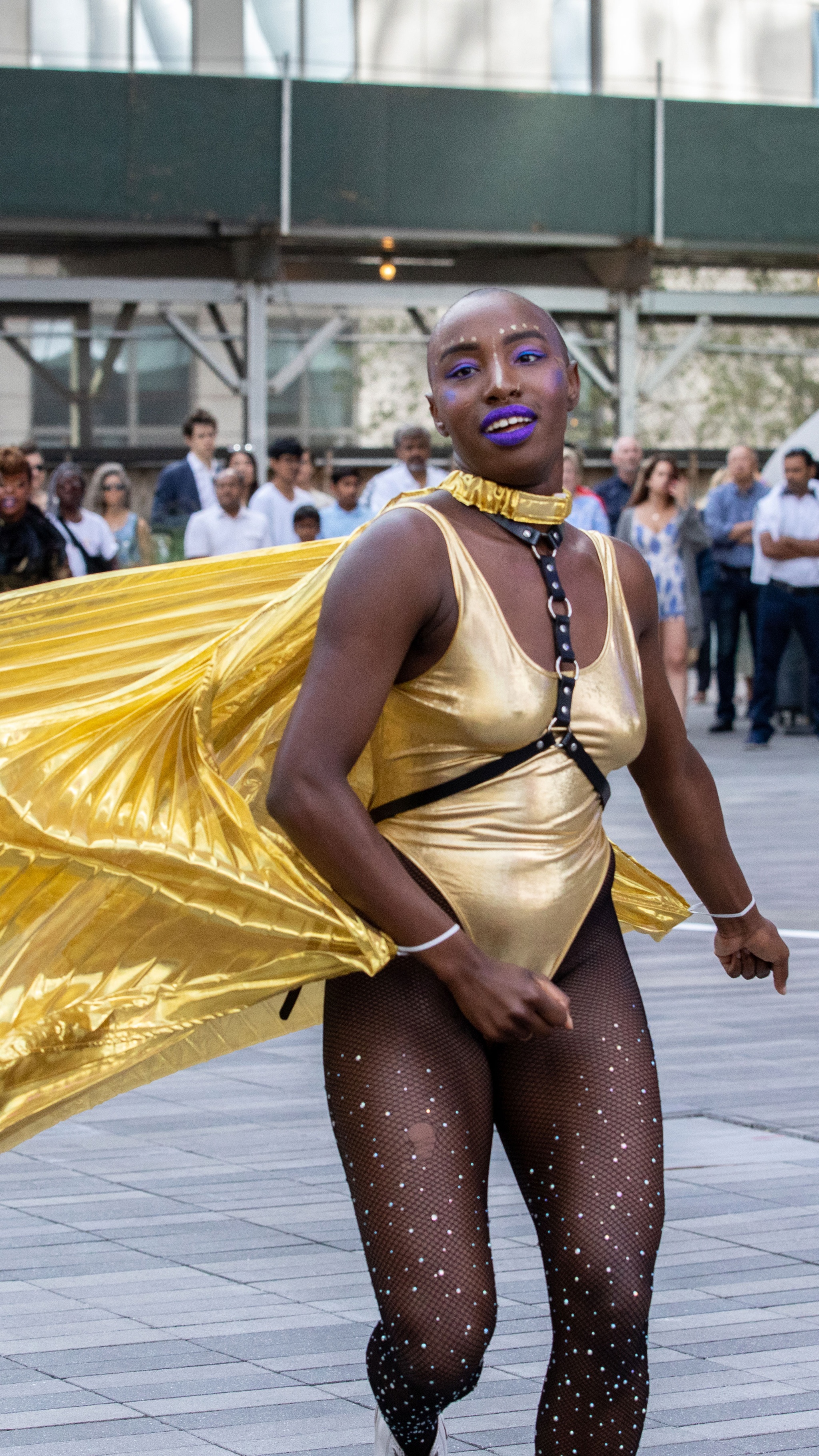 Ebony Noelle Golden running in metallic cape.