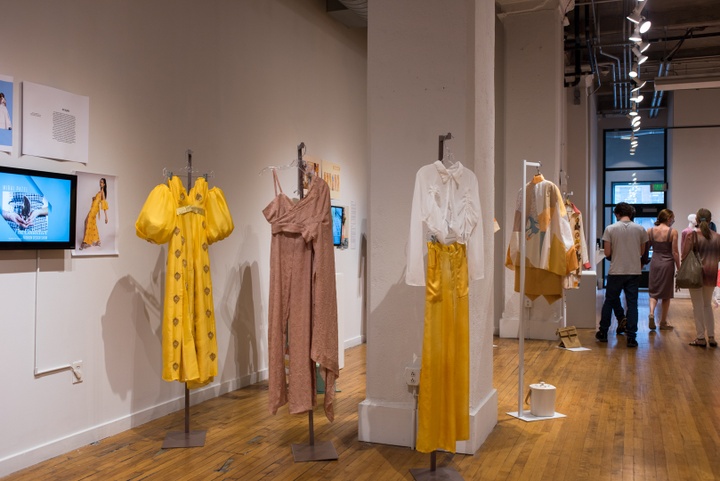 Three garments from a collection. Garments use goldenrod and mauve fabrics and include two flowy dresses and a blouse with satin skirt.