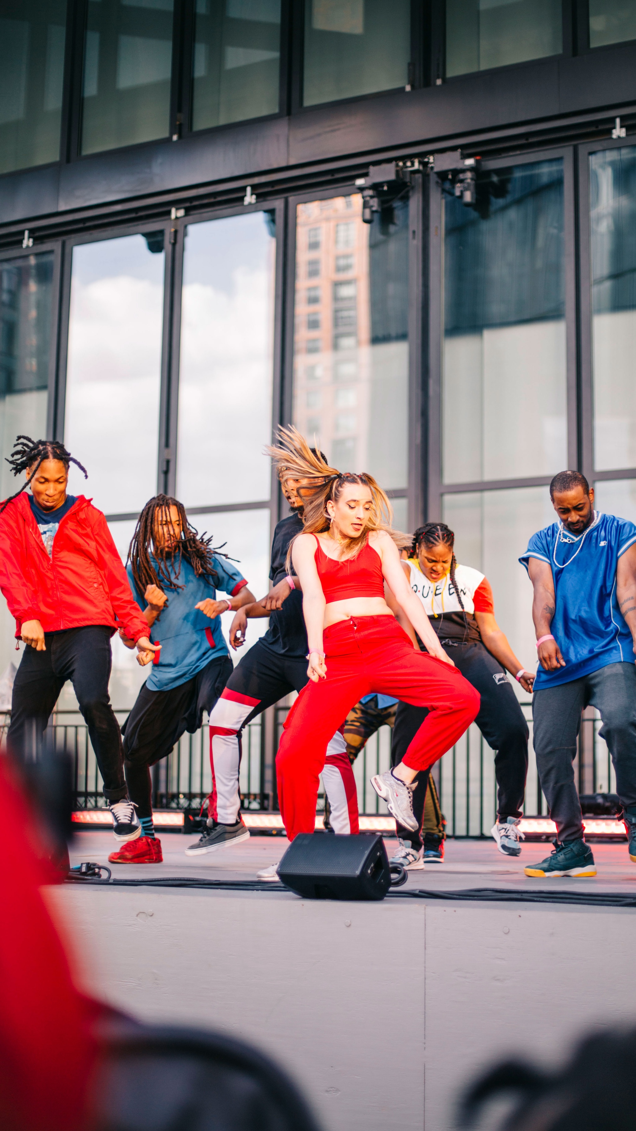 A group of dancers in motion on a stage.