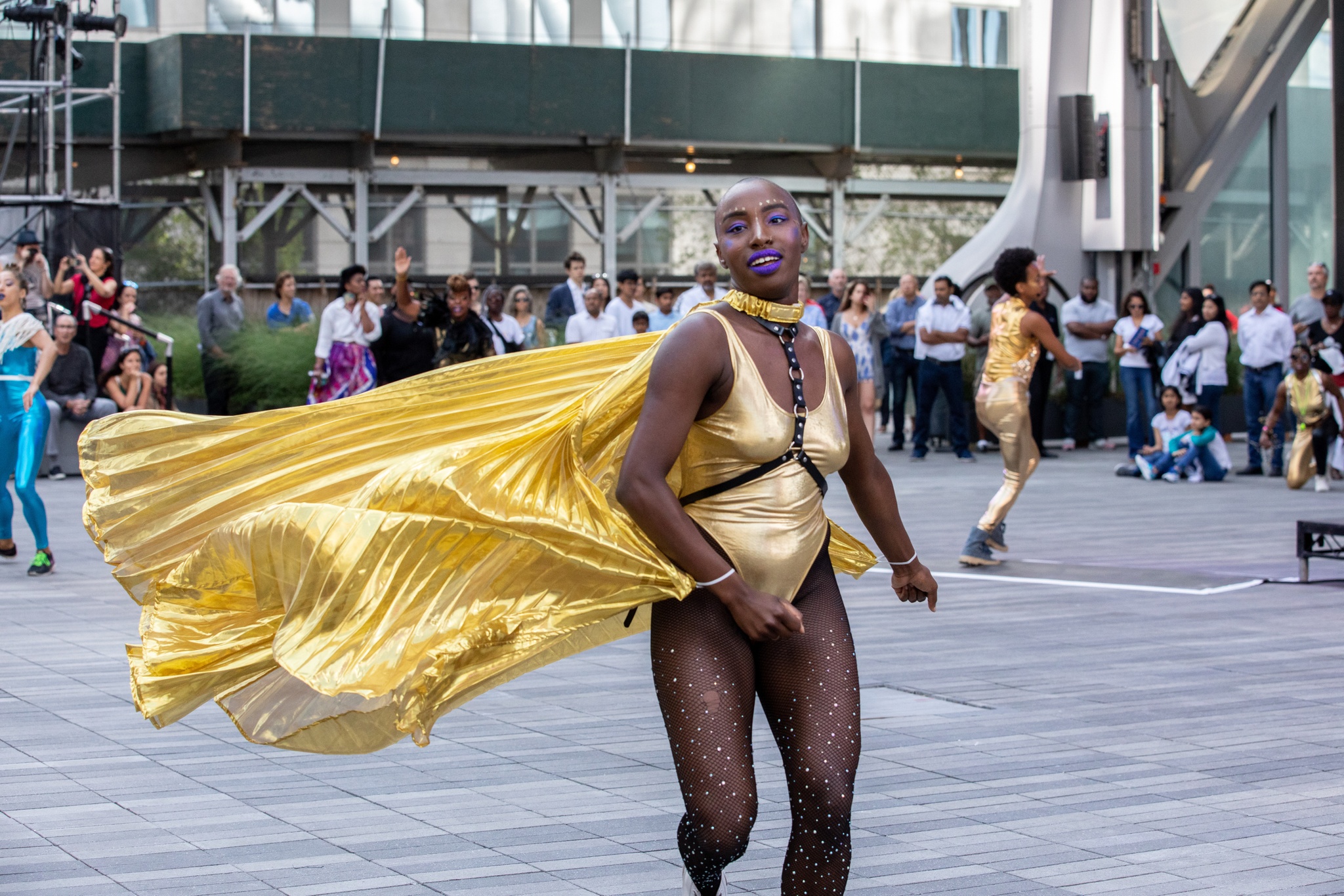 Ebony Noelle Golden running in metallic cape.