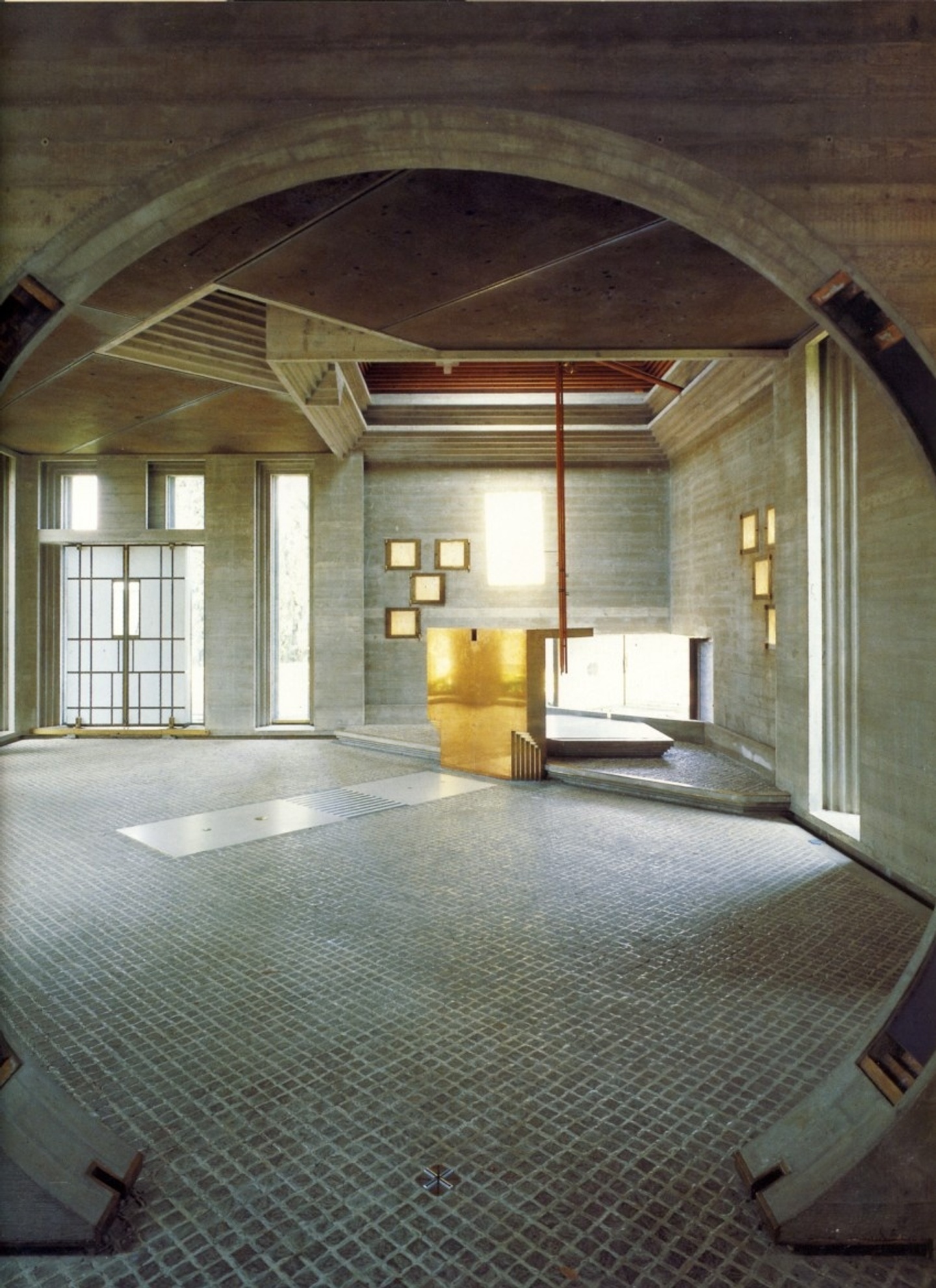 Photo of the entry to the chapel of Carlo Scarpa’s Brion Cemetery, San Vito d'Altivole. The arched entryway gives way to a bank of windows.