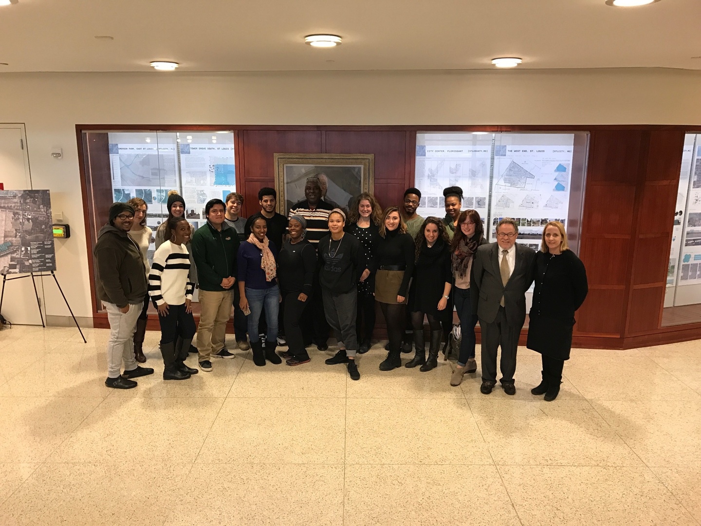 A group of people stand in front of a display case.