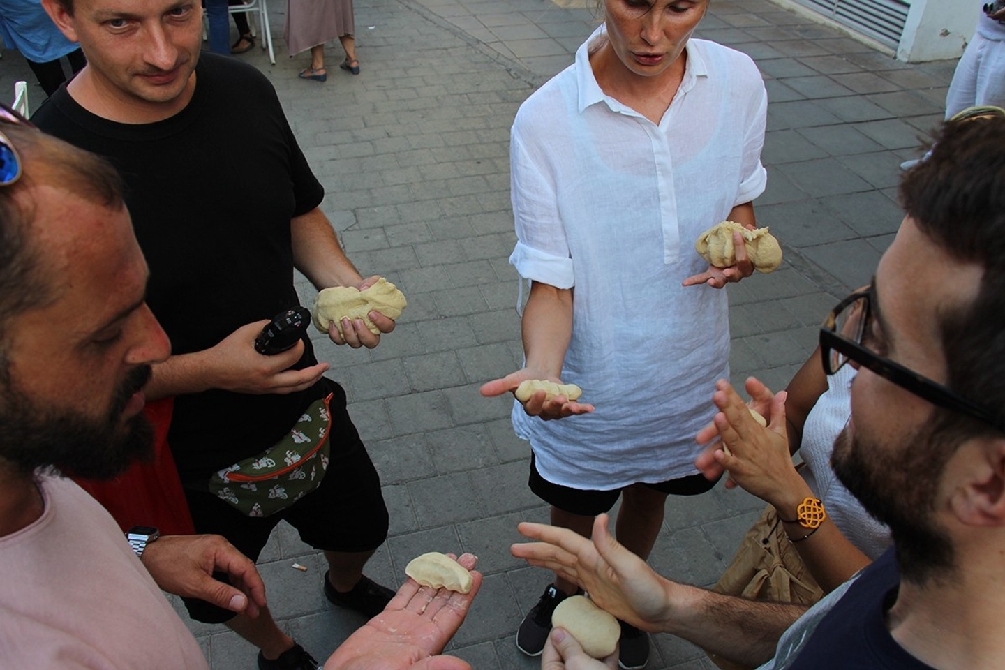 group of people sharing bread 