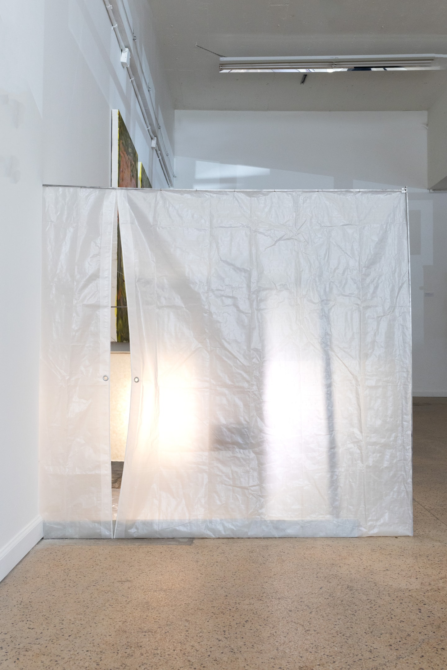 installation view wall of fabric and light