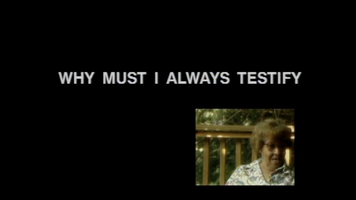 A small image of a woman wearing glasses inset in a black screen with the words "Why must I always testify"