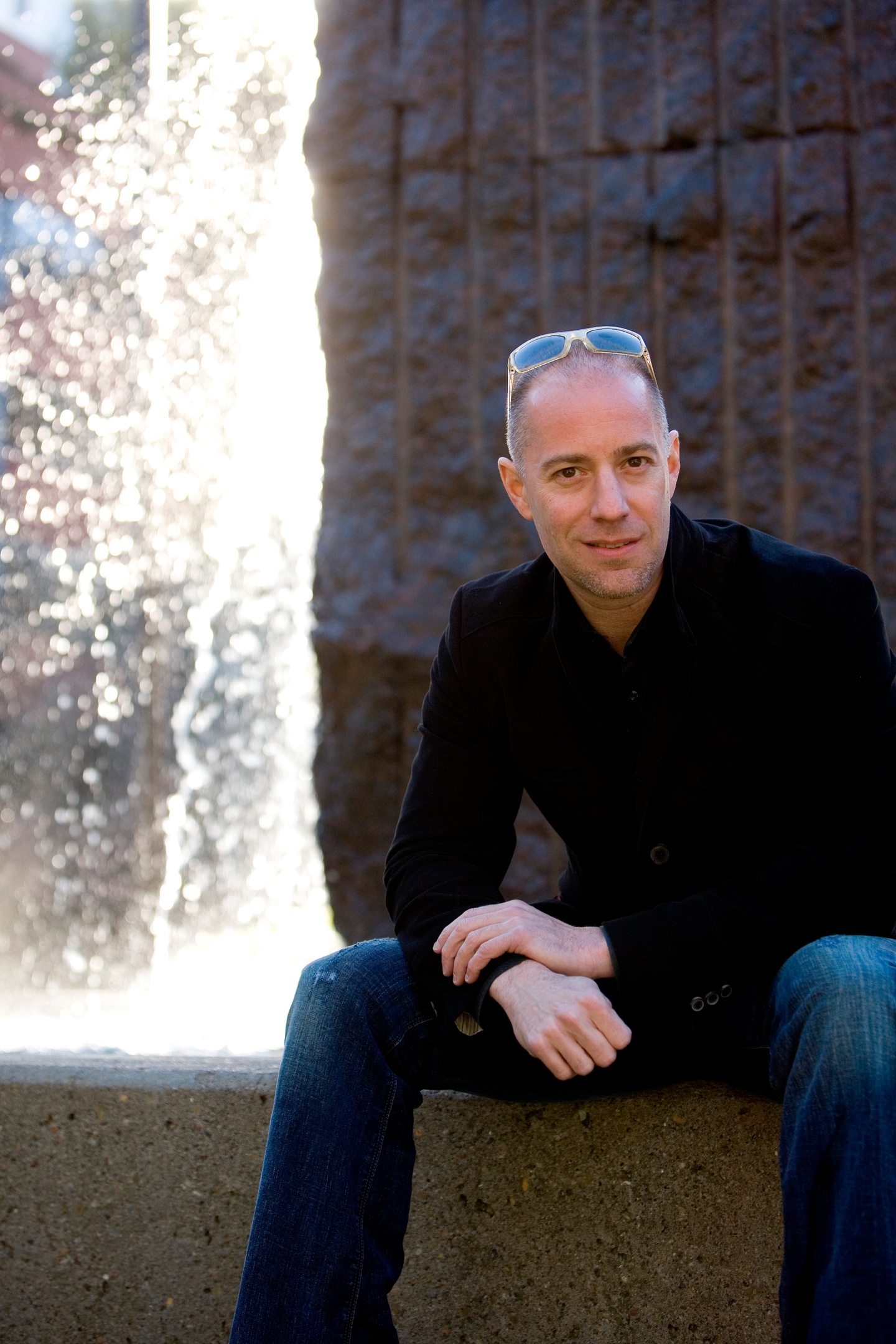 Portrait photo of Charles A. Birbaum sitting outside in front of a water feature.