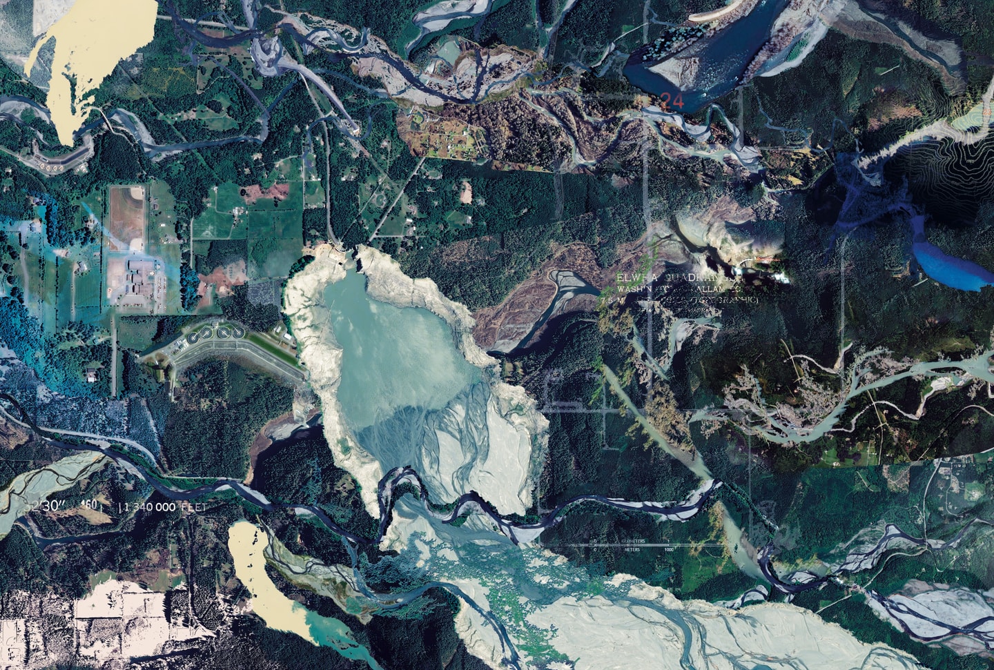 Carolina Caycedo’s Elwha’s Healing (2022/2026), an aerial satellite image of the Elwha River in Washington State showing forests, waterways, roads, agricultural fields, and a large reservoir, overlaid with topographic markings and text. The image depicts the river’s recovery following the removal of two hydroelectric dams.