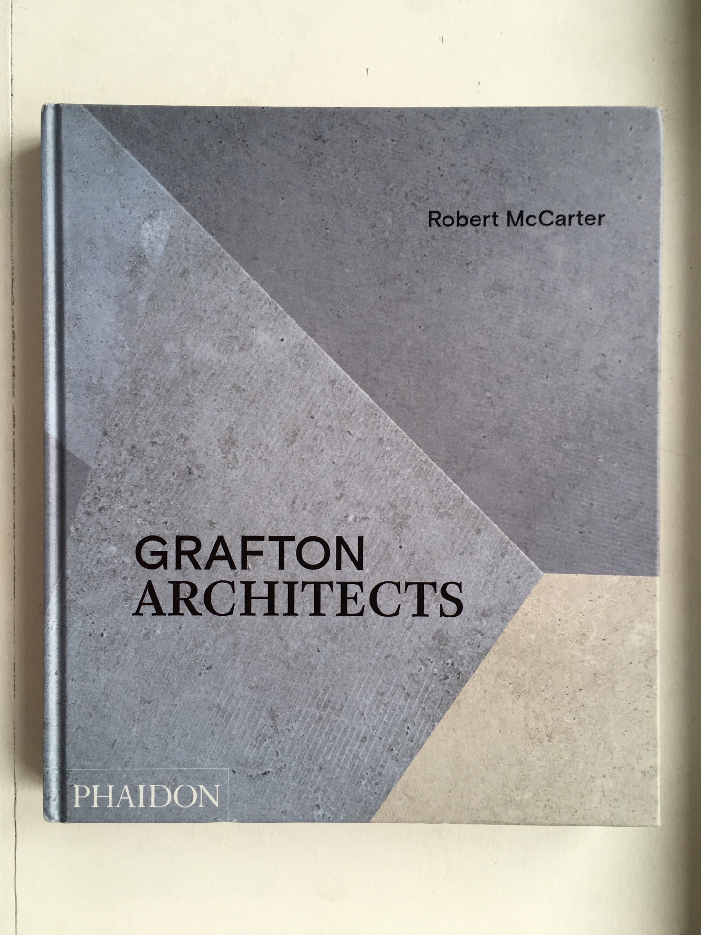 Cover of Grafton Architects, featuring three trapezoids—two in shades of gray, one more of a cream color.