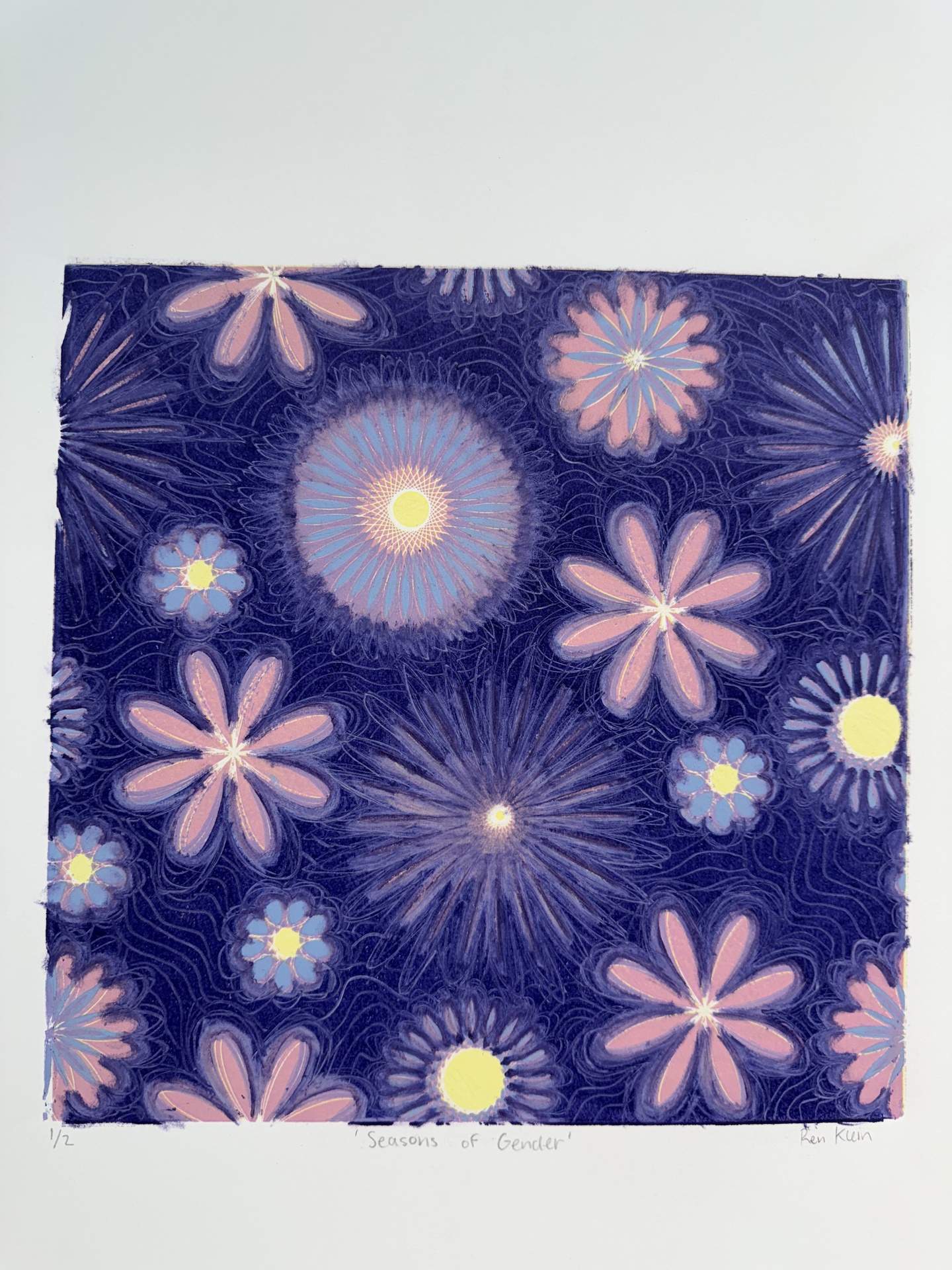Linoleum cut print of an illustration flower pattern on a dark blue background.