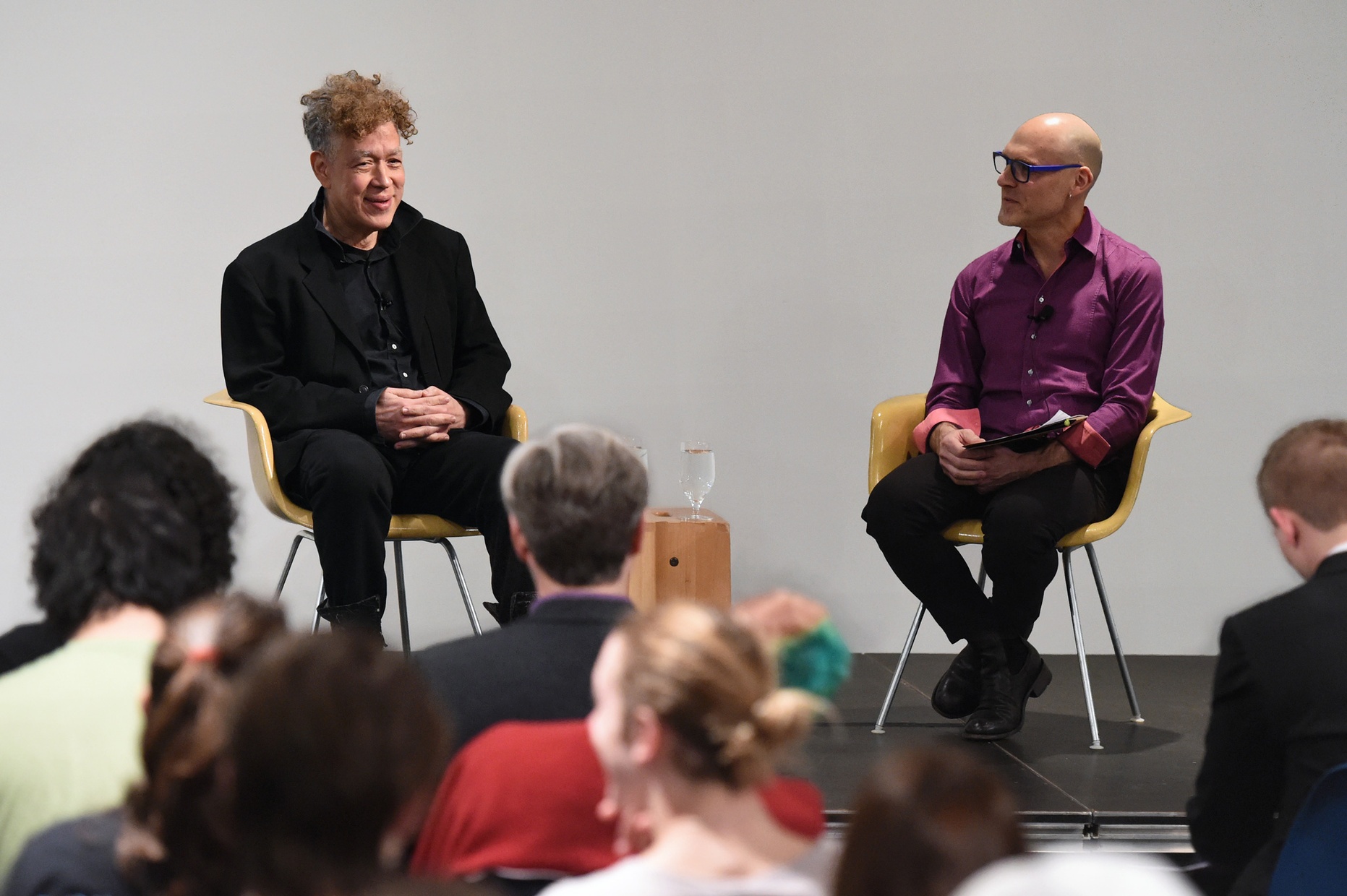 Andres Serrano and Robert ParkHarrison sit in front of an audience during a discussion