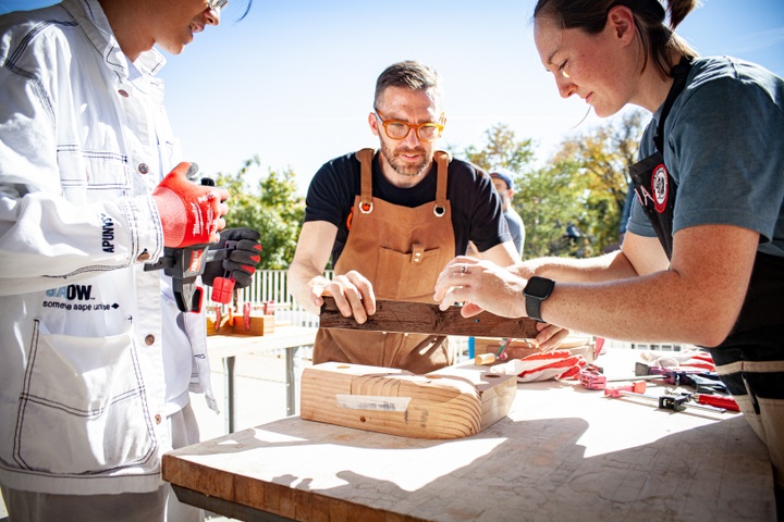 Greg Cuddihee holding up a long piece of wood in demonstration