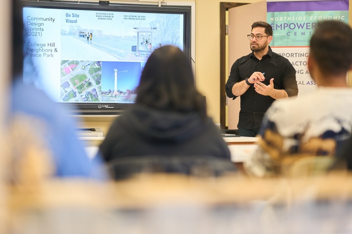 Lecturer Matthew Bernstine presents to a classroom of students and community partners.