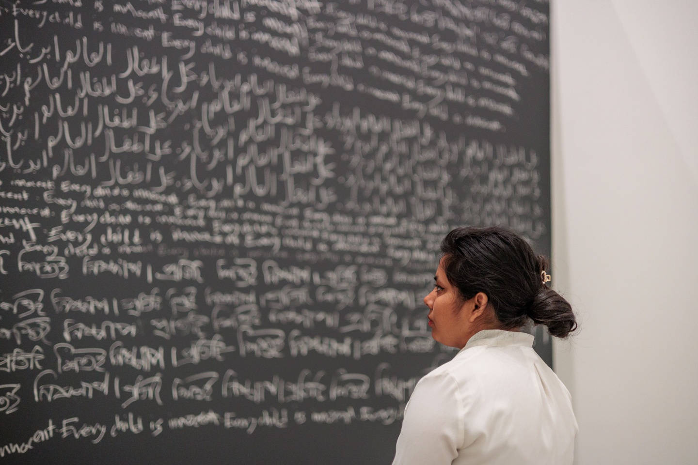 The artist stands in front of installation piece