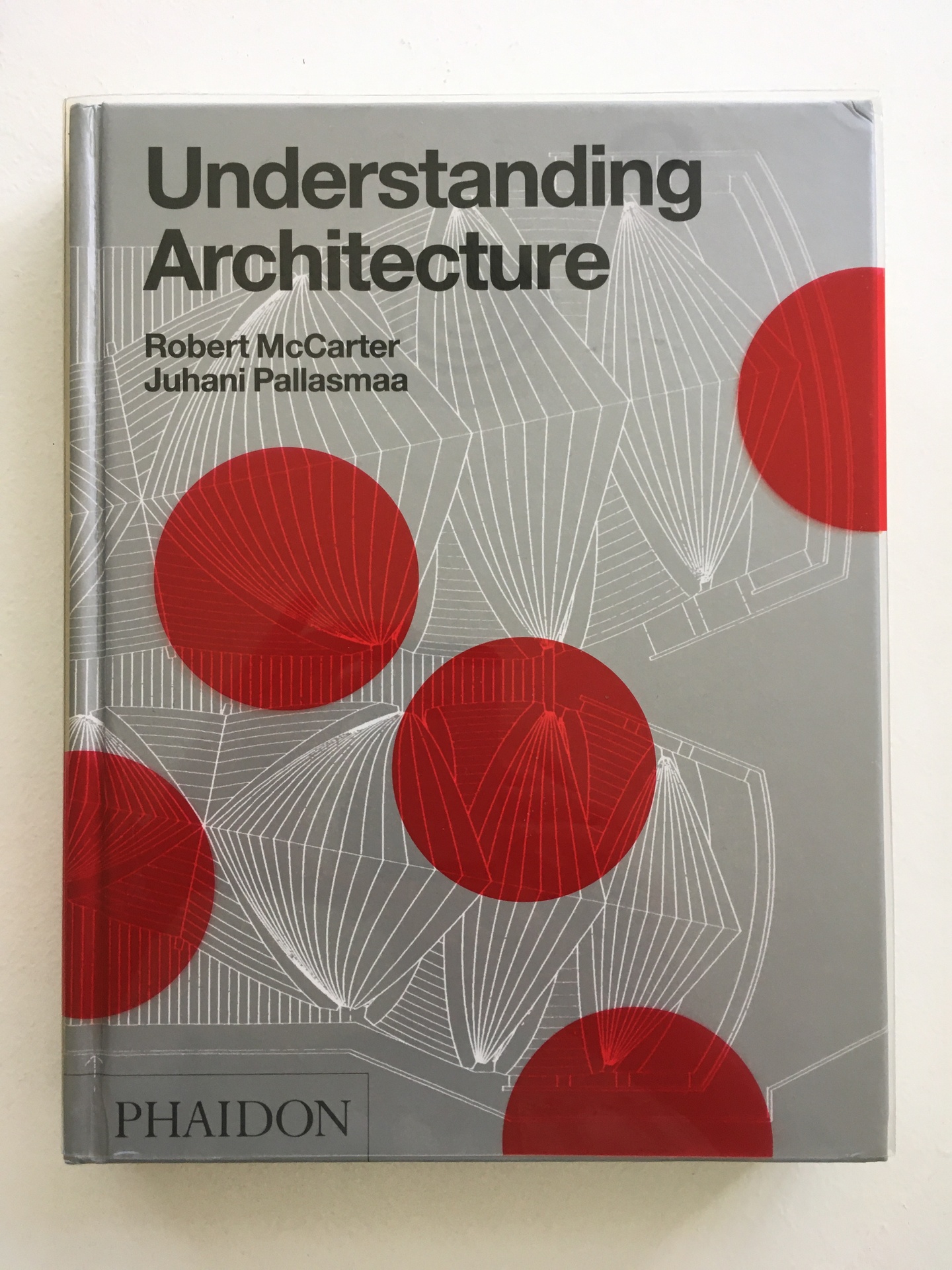 Cover of Understanding Architecture, with a blue-gray background with white 3D linework and red circles over the top.