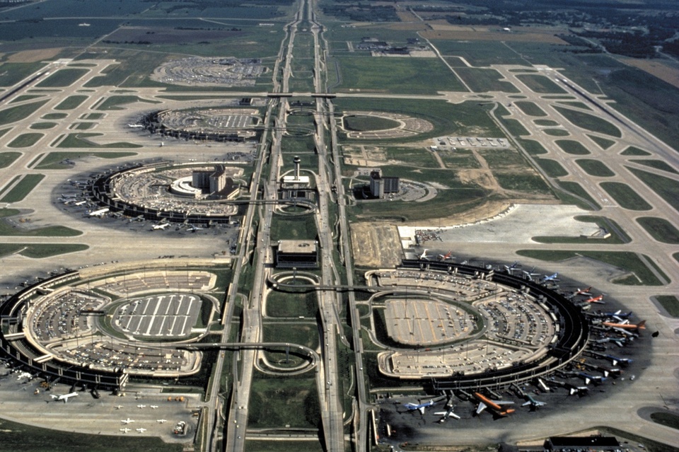 Aerial view of a massive airport structure and roadways