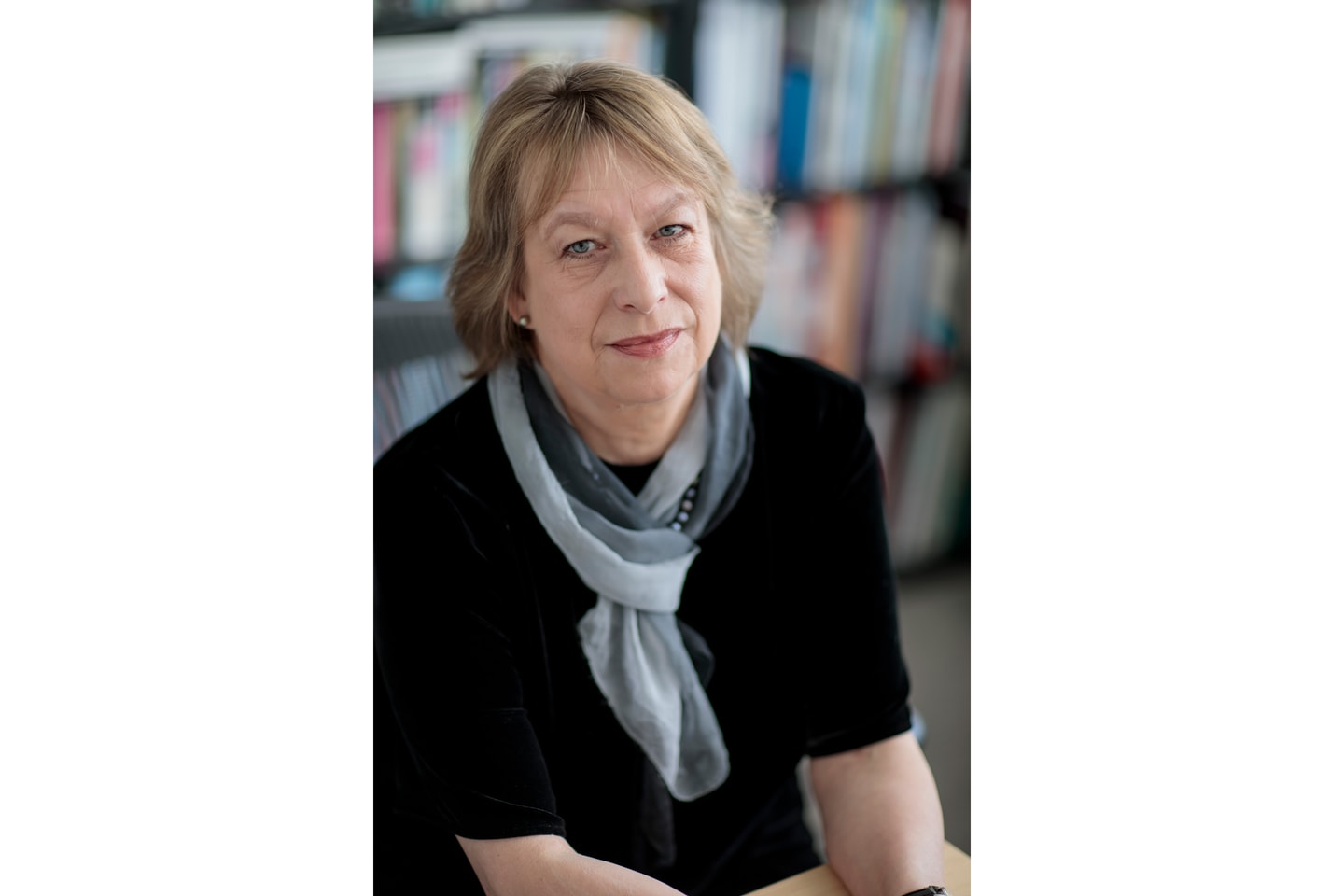 portrait of Sabine Eckmann wearing a black shirt and colorful scarf