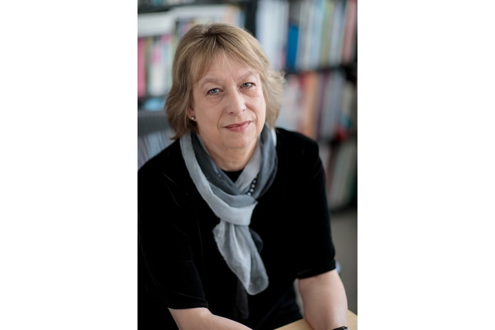 portrait of Sabine Eckmann wearing a black shirt and colorful scarf