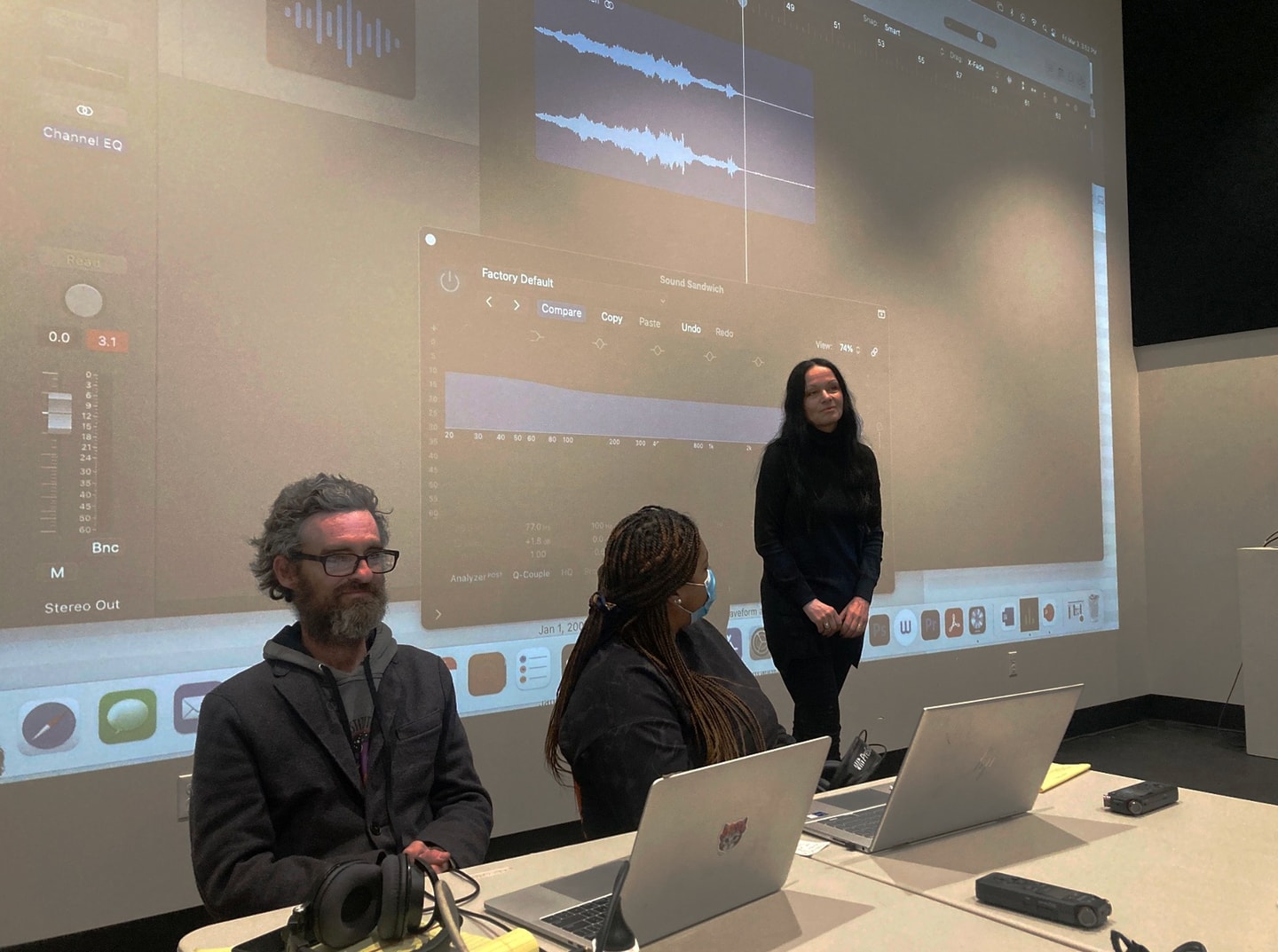 three people in a front of a screen presenting in the Weil Media Studio