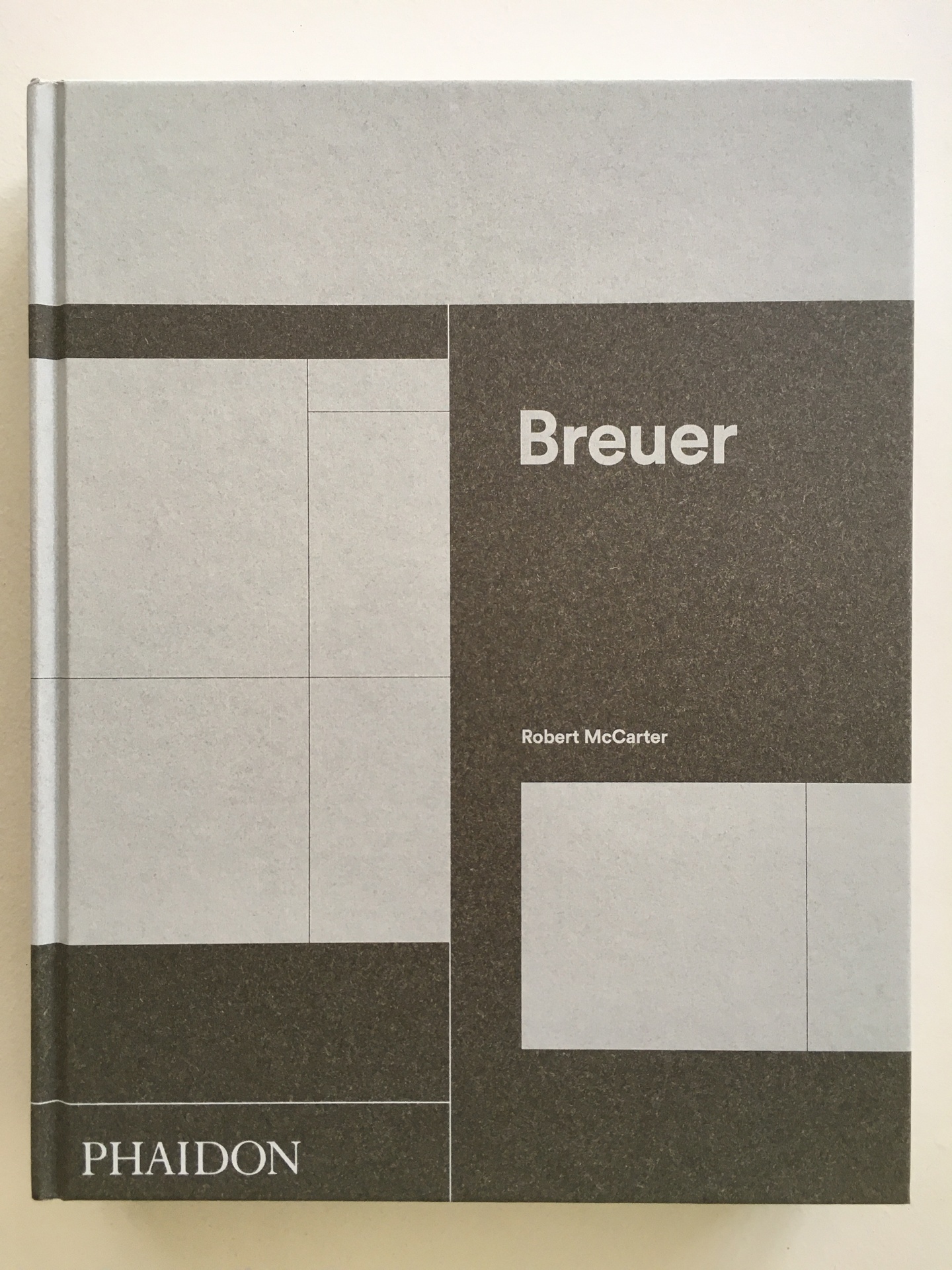 Cover of Marcel Breuer, featuring a couple of subdivided, white rectangles against a brown, granulated background