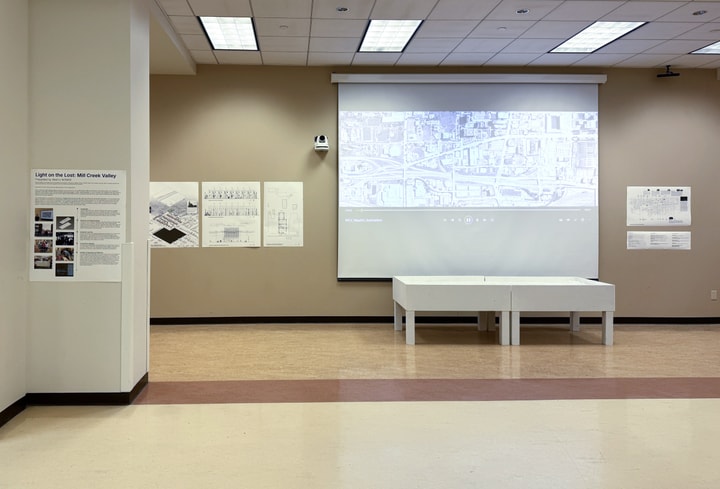 gallery exhibition in a large room with projections and information on the walls