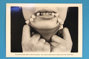 By placing fake teeth under her pillow... Postcard