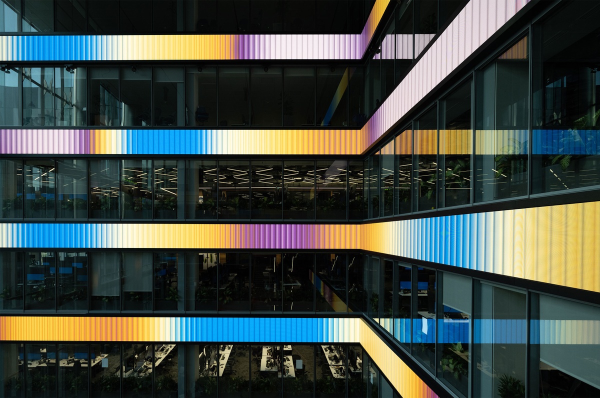 View of four LED screens with yellow, purple and blue gradients