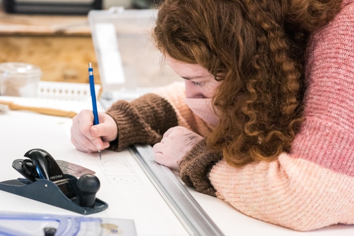 Close up of a person working on a drawing.