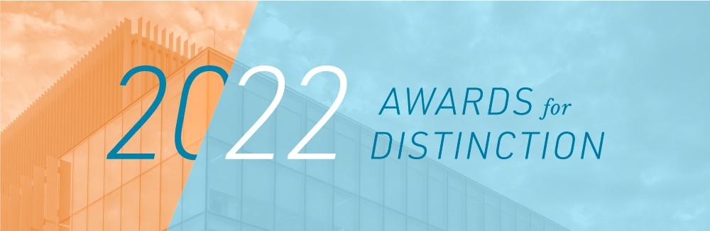 Orange and light blue graphic for the 2022 Awards for Distinction, with a building visible behind the color screens.