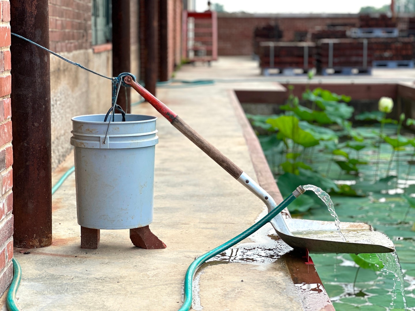 a hose over a shovel going into a pool