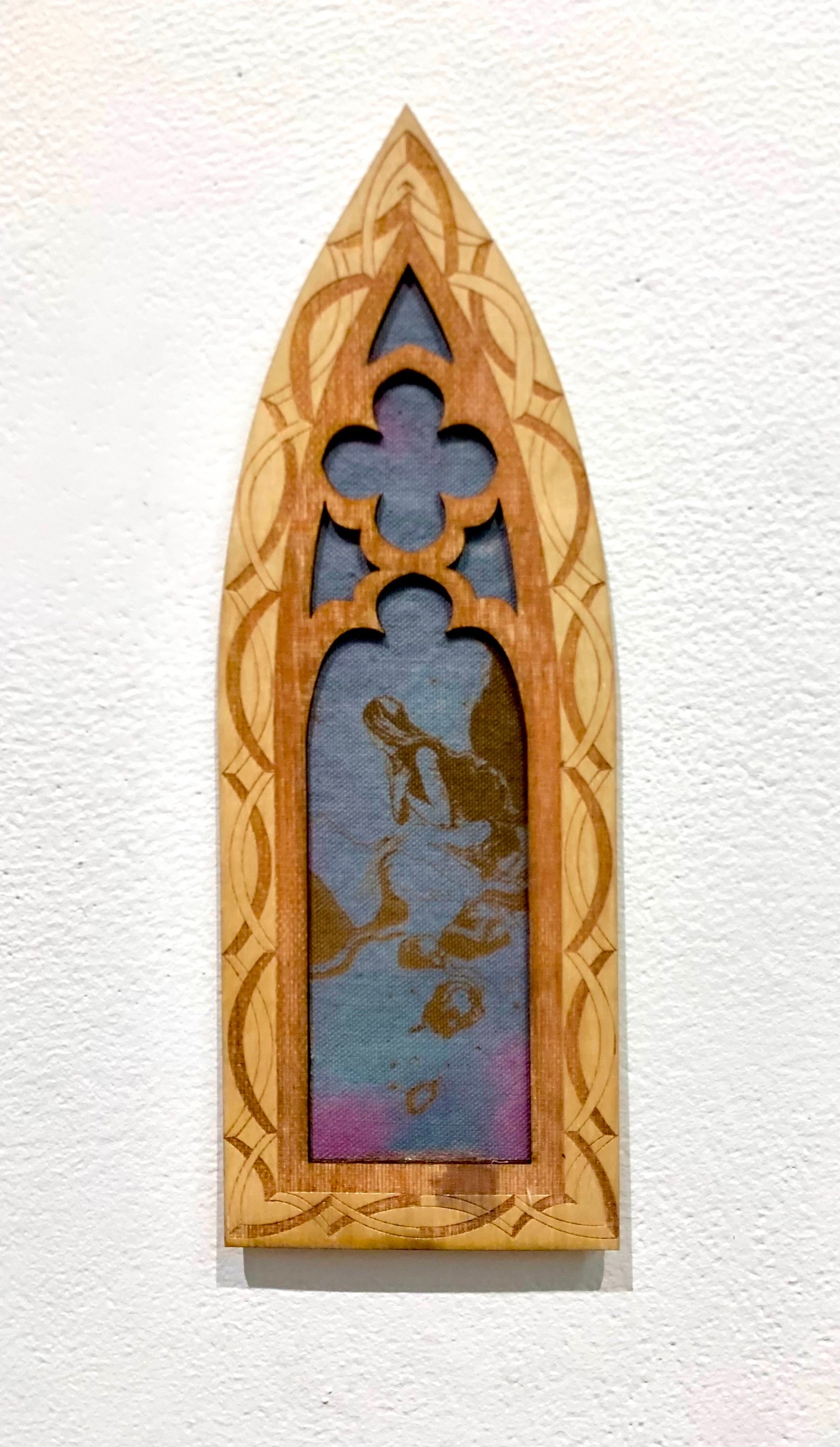A sculpture and a painting resembling a church window. 