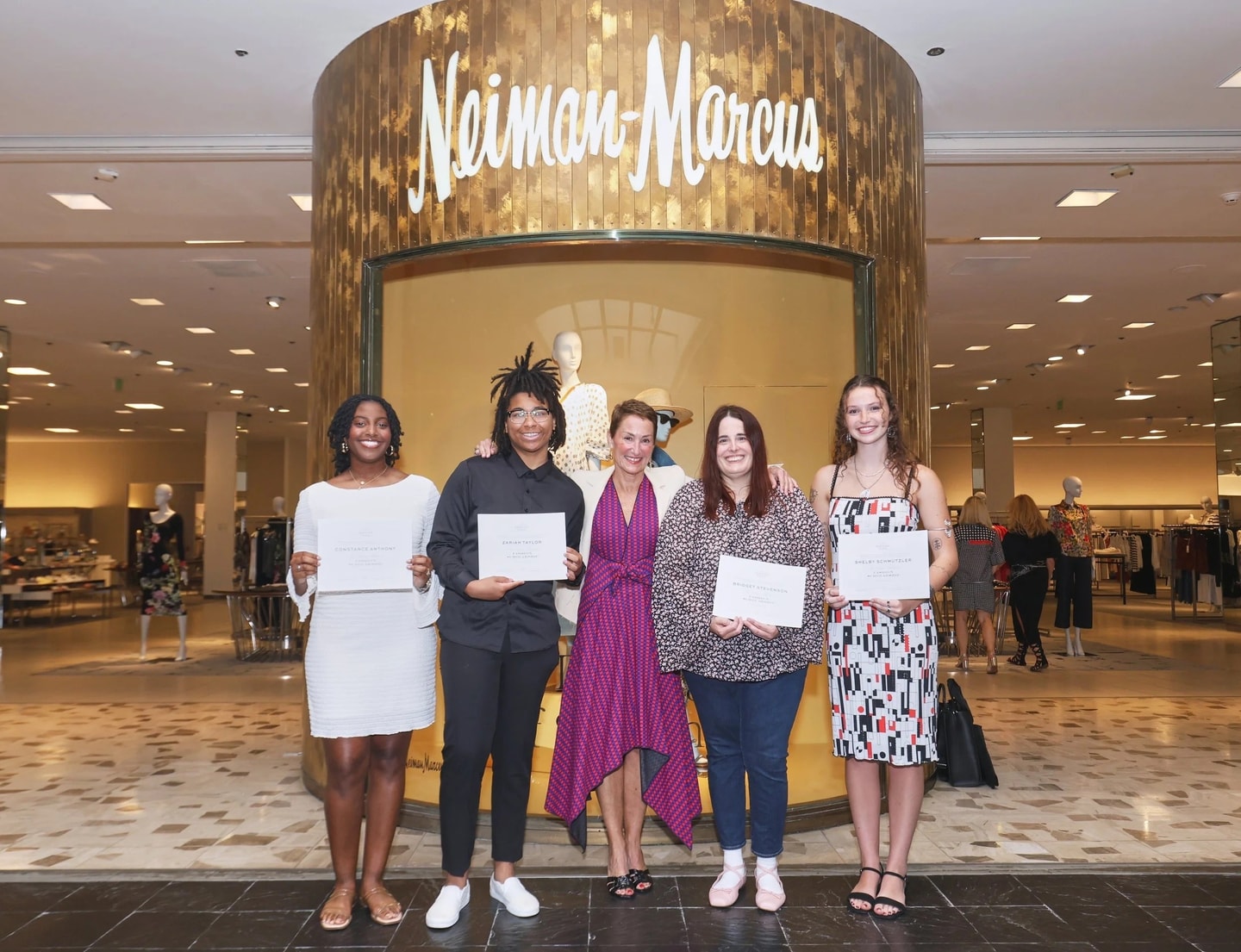 5 people standing together with certificates at a ceremony