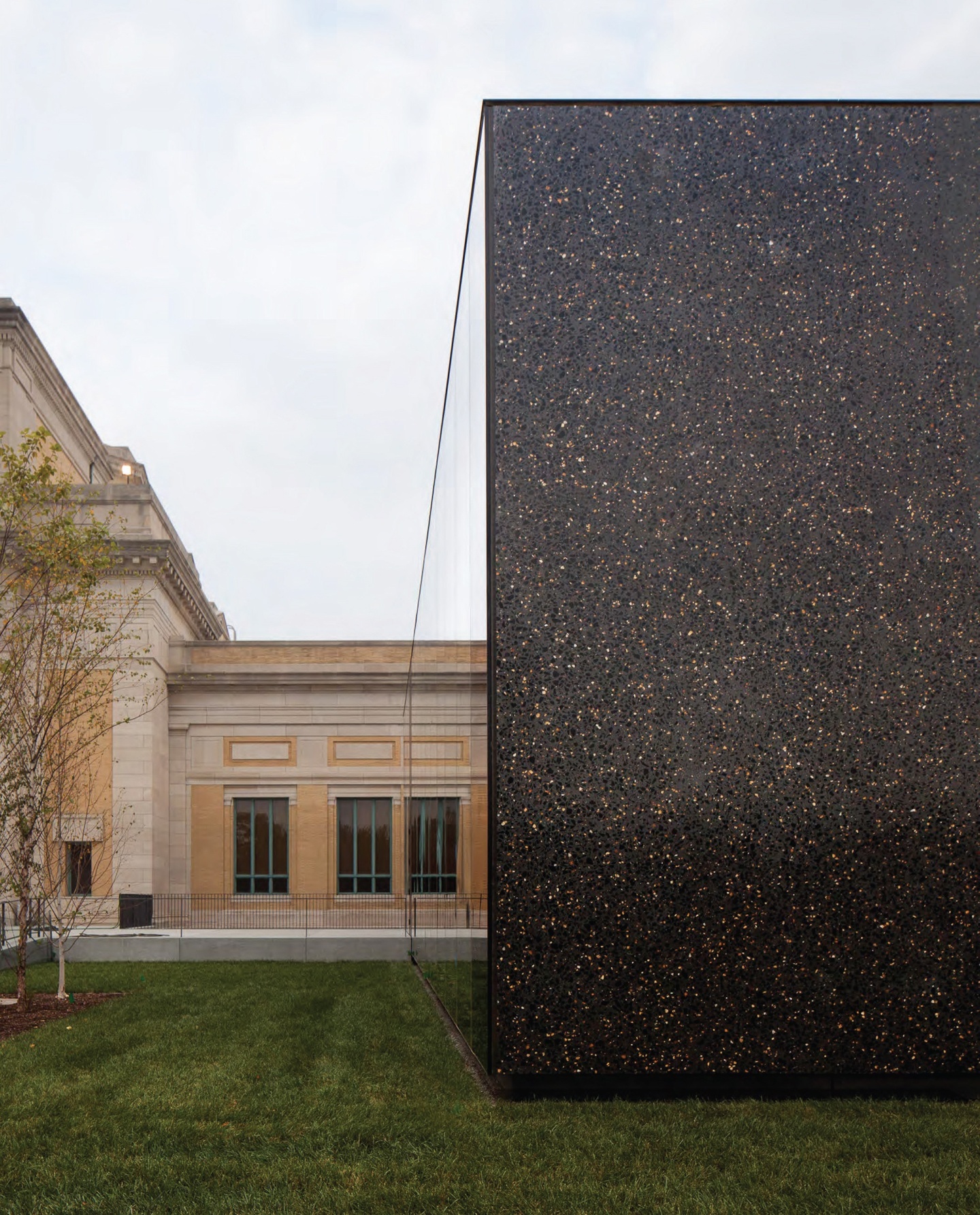 Dark concrete facade of one face of the Saint Louis Art Museum expansion, with the original building to the left.