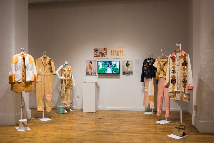 Collection of six garments in a collection. The colors are earthy golds and pinks and dried fruit and leaves are used as accents.