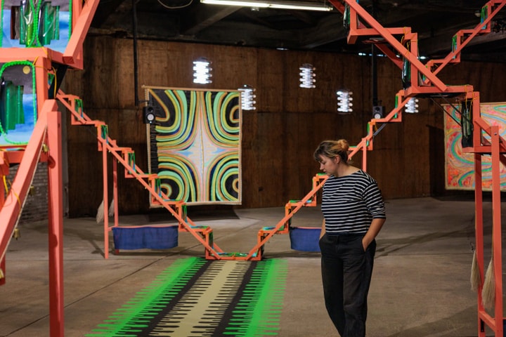 Dallas spears walking through artwork by Lisa Alvarado and Joshua Abrams