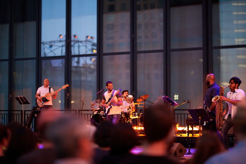 Band playing on outdoor stage.