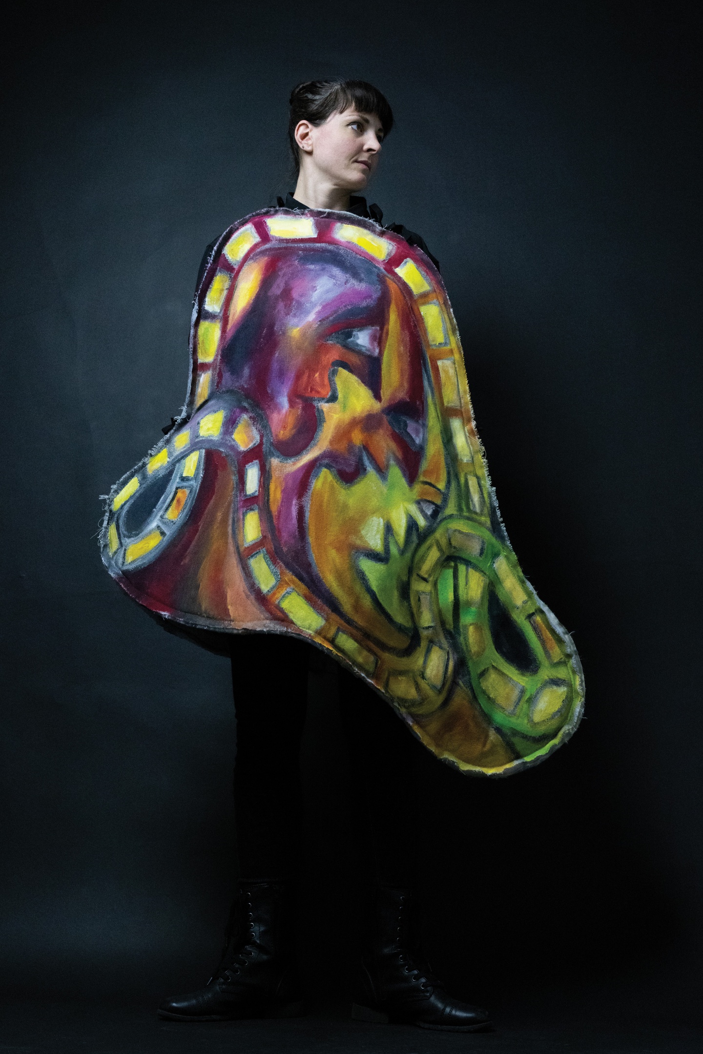 A person wearing a colorful abstract painting. 