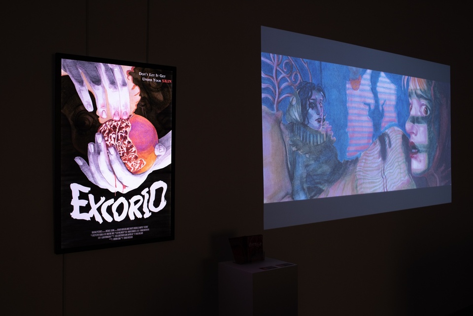 Film poster for Excorio and still from projection on a black wall space. The poster has an illustration of two white hands peeling a pomegranate, and the video still is an illustration of two frightened-looking women sitting on a bed.