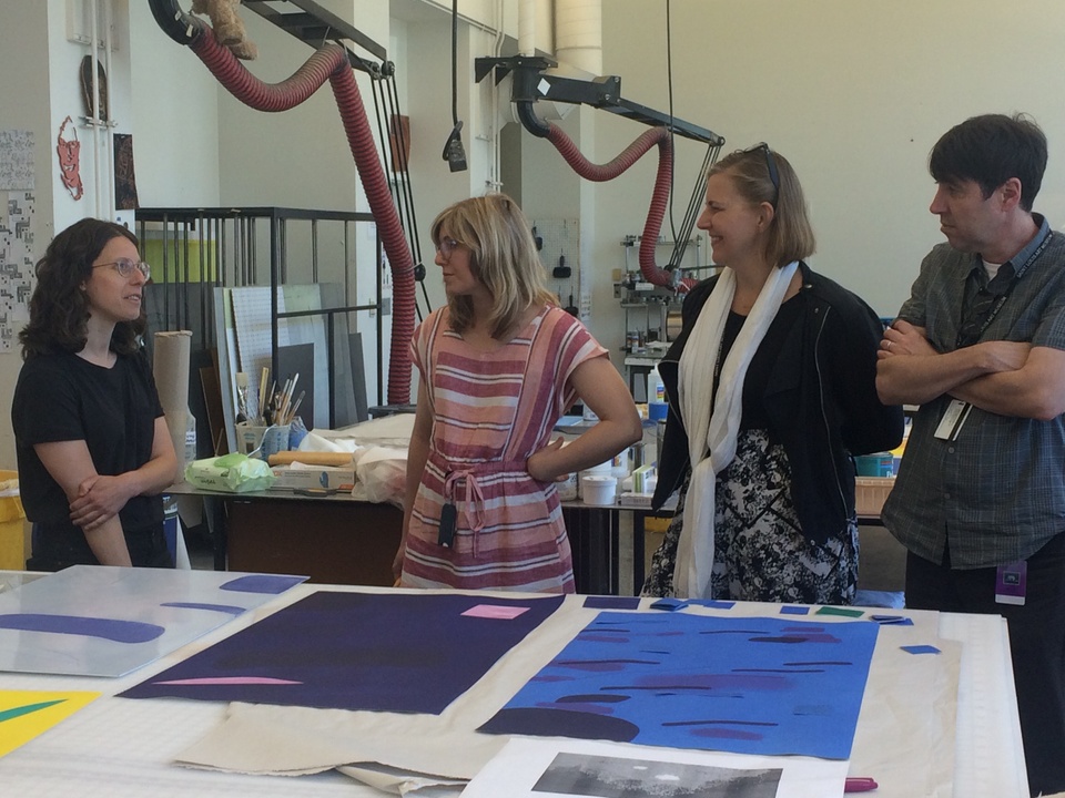 Artist talking to curators in the print shop