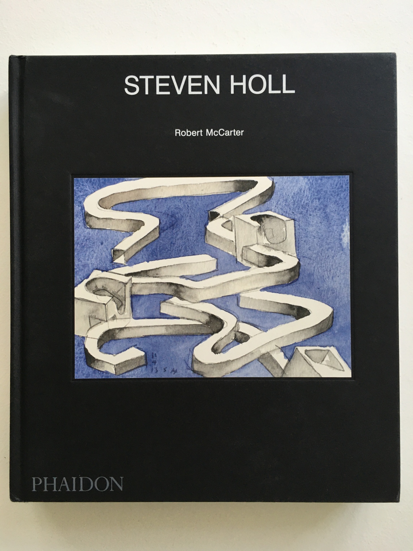 Cover of Steven Holl, featuring a largely black background with a square featuring a black background and 3D, serpentine white object