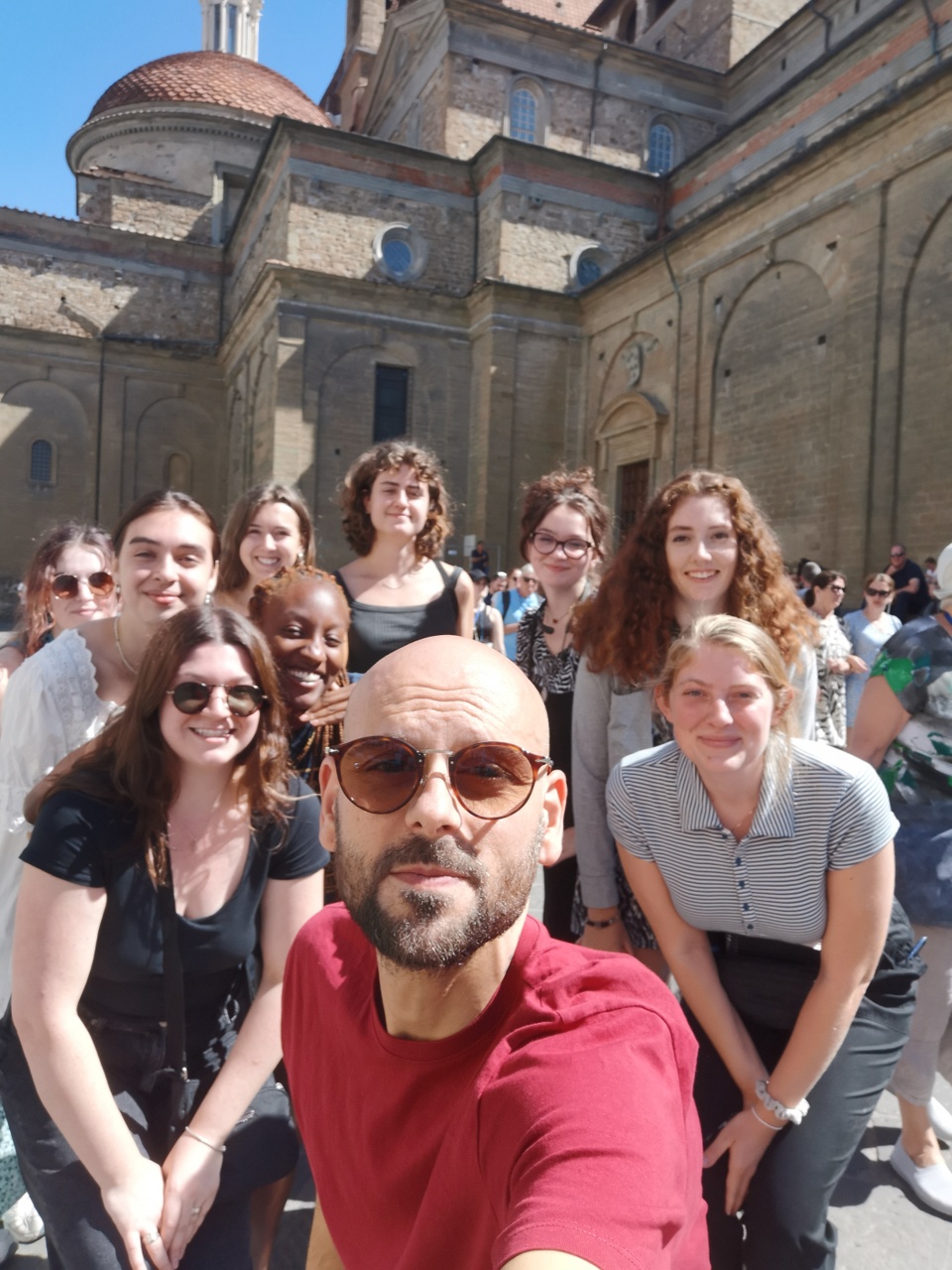 Angelo with students behind him in front of the Church of San Lorenzo