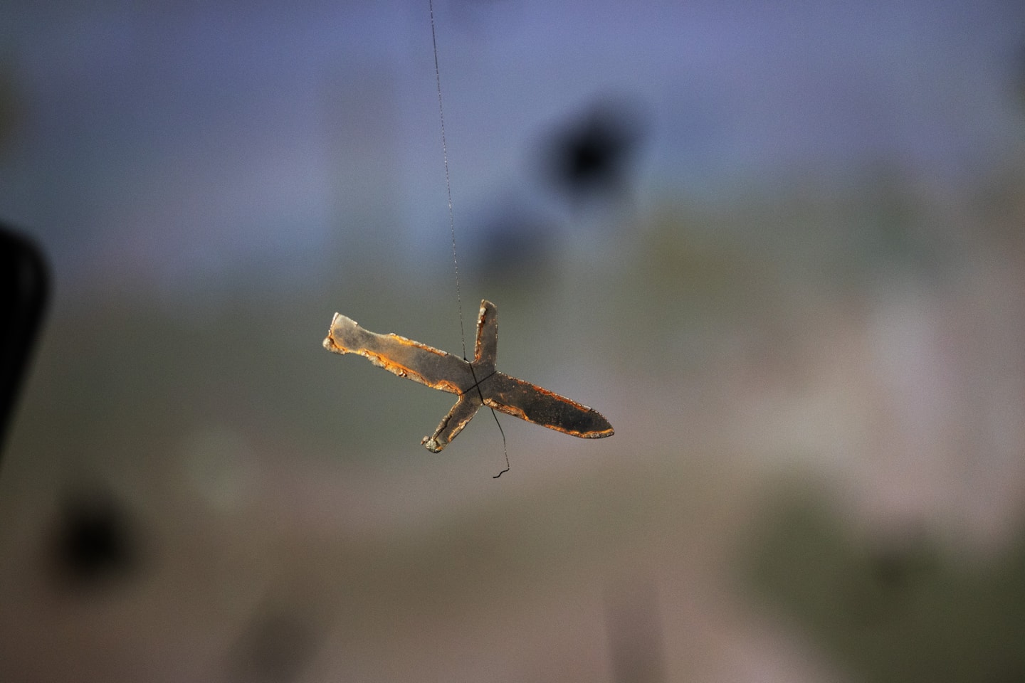 still of film, small sword like object moving across blurred background