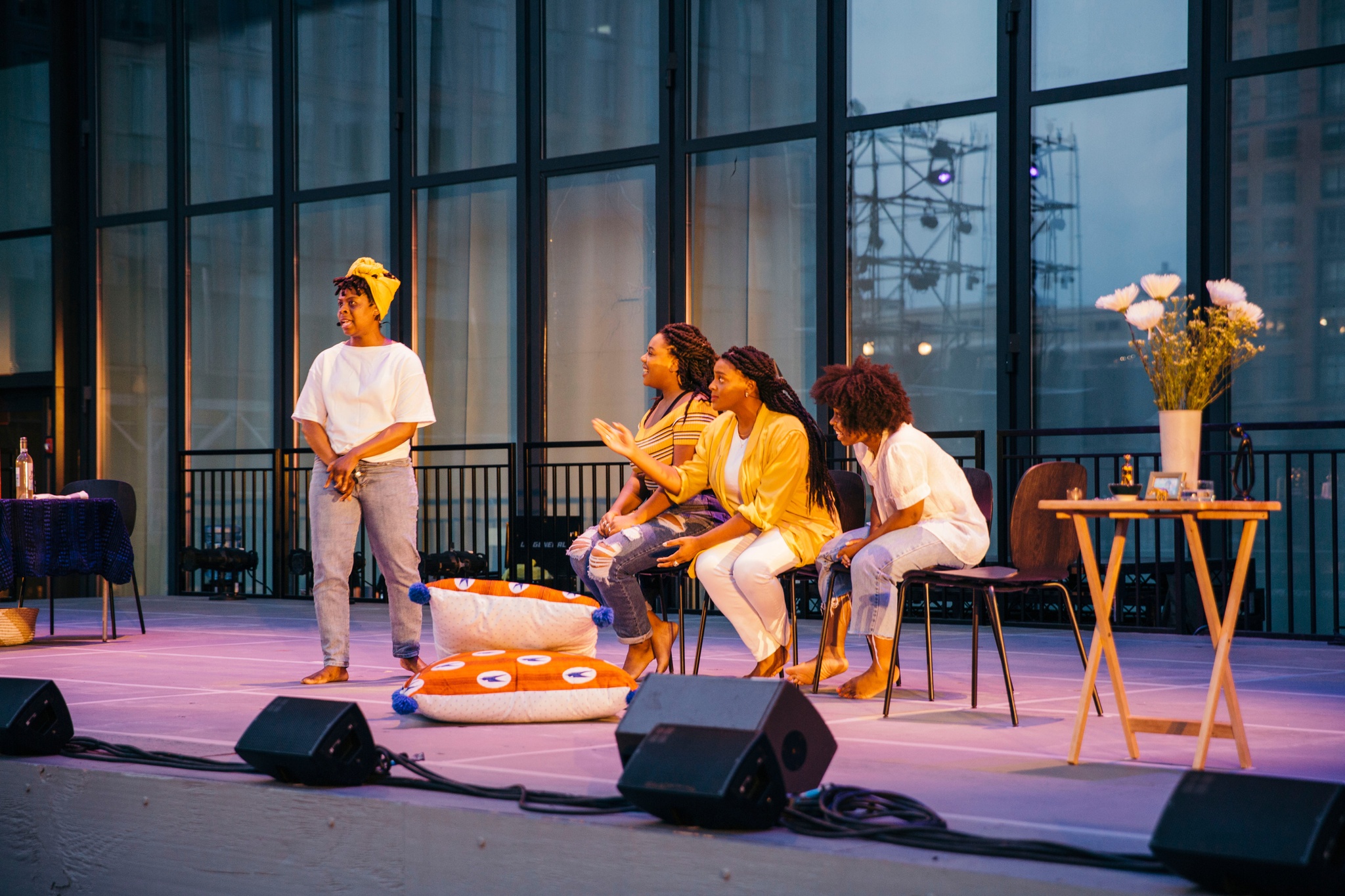 Four women acting on stage barefoot.