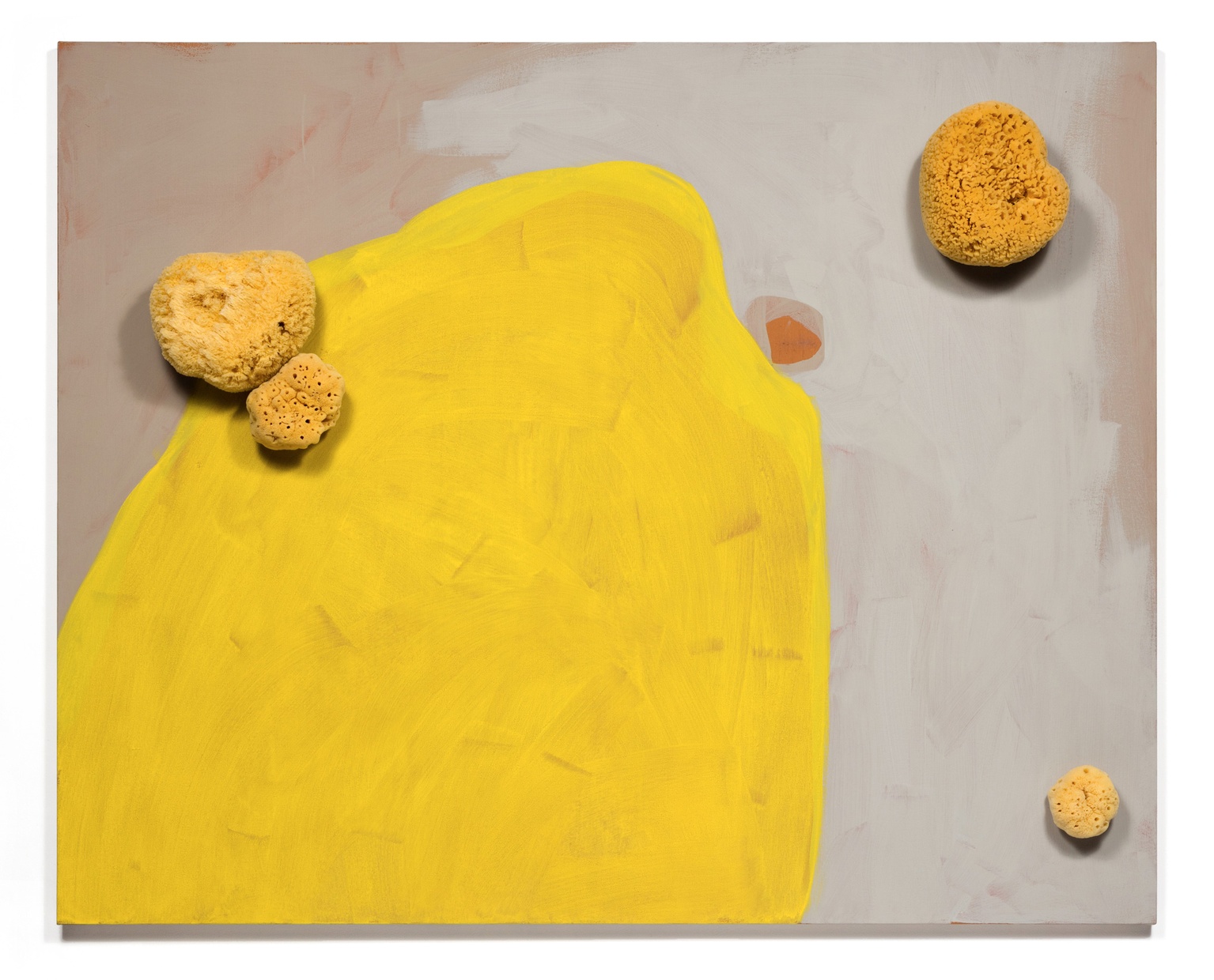 A yellow and tan abstract painting with yellow-painted round sponges attached to the canvas.
