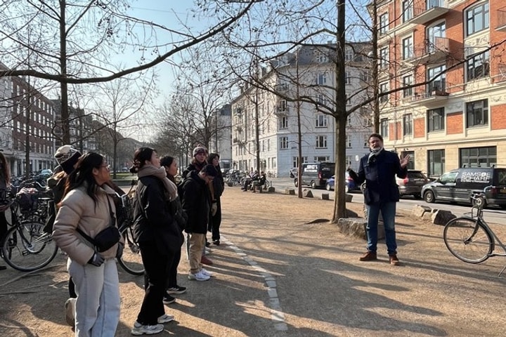 A man speaks to a group of students outside 