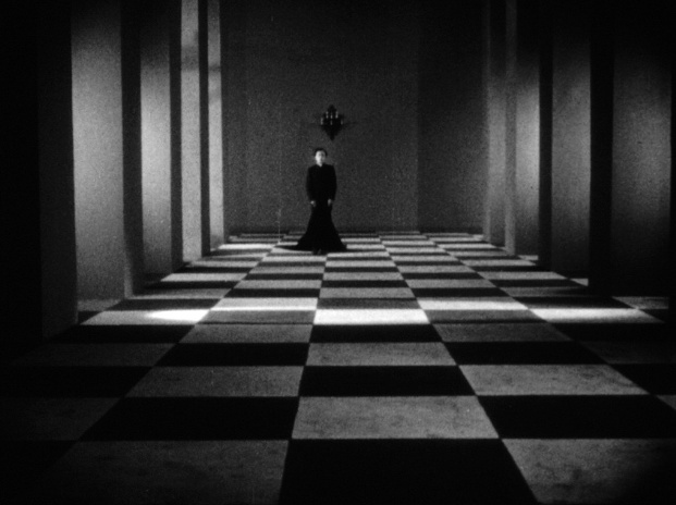 A figure stands at the end of a long hallway with white and black checkered tiles